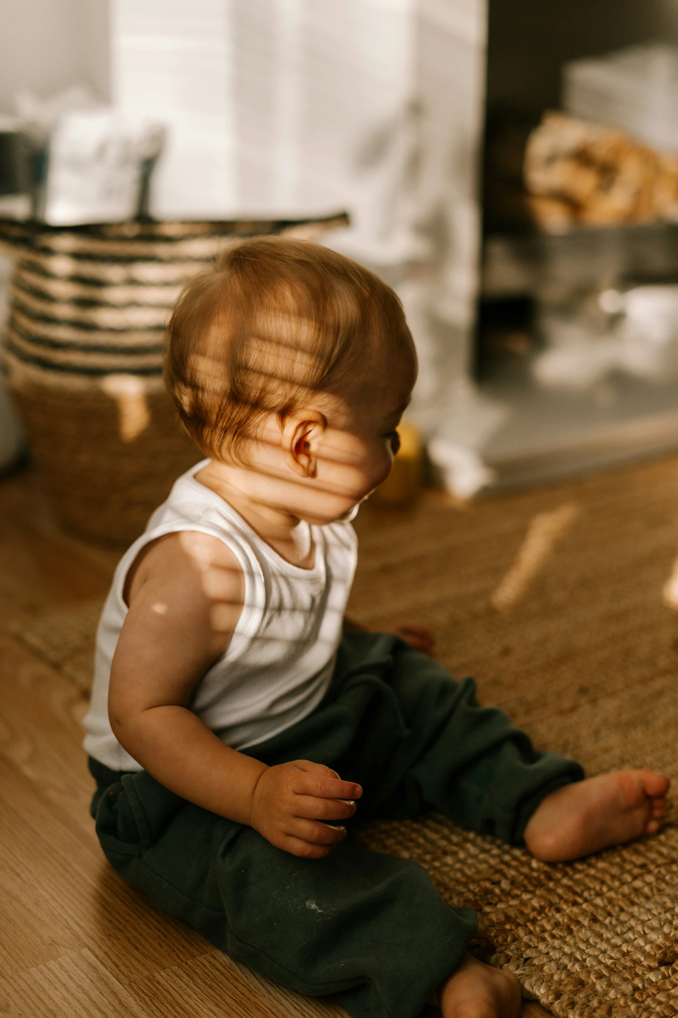 A baby sitting in warm morning light